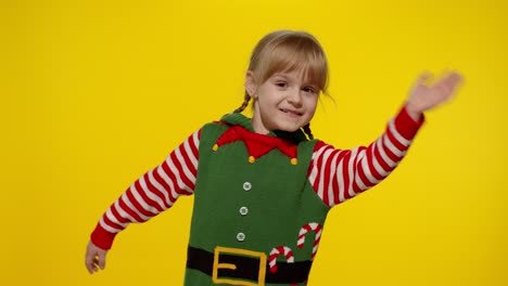 Girl-in-Christmas-elf-Santa-helper-costume-waving-greeting-with-hand.-Hello,-hi,-greetings-gesture