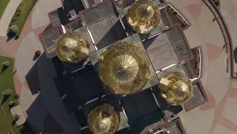 Dome-of-the-church,-aerial-view,-traditional-old-church-in-Lviv,-Ukraine-city,-cloudy-blue-sky