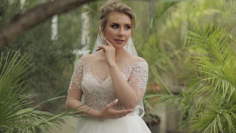 Beautiful-and-lovely-bride-in-wedding-dress-in-the-park.-Slow-motion