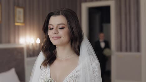 Newlyweds-young-caucasian-bride-and-groom-first-meeting-at-wedding-day,-making-a-kiss-indoors