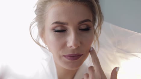 Beautiful-and-lovely-bride-in-night-gown-and-veil.-Wedding-morning.-Slow-motion