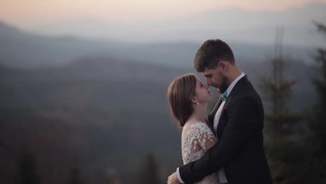 Newlyweds.-Caucasian-groom-with-bride-on-mountain-slope.-Wedding-couple.-Happy