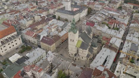 Aerial-drone-video-panorama-of-Latin-Cathedral-in-city-Lviv,-Ukraine,-flight-above-roofs,-streets