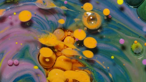 Ink-bubbles-mixed-with-liquid-substance-of-oil,-milk,-soap,-bright-acrylic-paint-on-colorful-surface