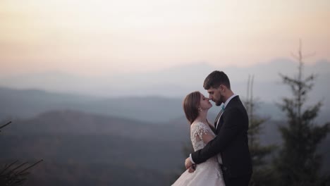 Newlyweds.-Caucasian-groom-with-bride-on-mountain-slope.-Wedding-couple.-Happy