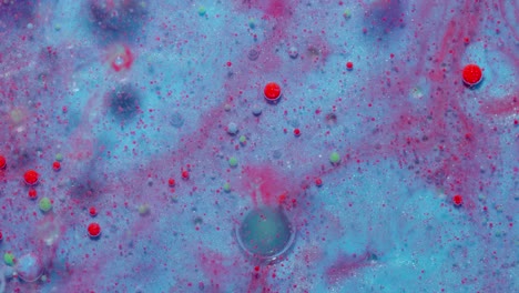 Ink-bubbles-mixed-with-liquid-substance-of-oil,-milk,-soap,-bright-acrylic-paint-on-colorful-surface