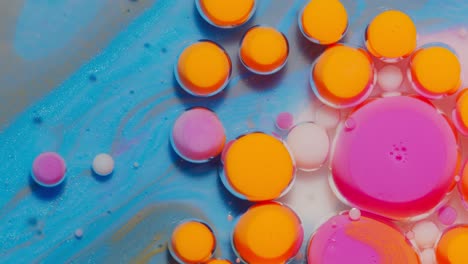 Bright-neon-colorful-bubbles-oil-and-ink,-acrylic-paint-moving-close-up,-wallpaper-background