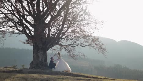 Newlyweds.-Caucasian-groom-with-bride-on-mountain-slope.-Wedding-couple.-Happy