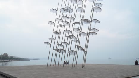 Couples-sitting-under-umbrellas-in-Thessaloniki