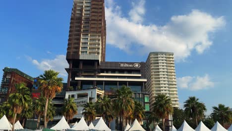 Pattaya-Thailand-Hilton-hotel-holiday-building-beachfront-sandy-beach,-palm-tree-street