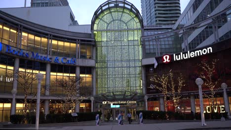 CF-Toronto-Eaton-Centre-side-entrance-near-city-hall-with-winter-Christmas-lights-decorations-on-trees-during-winter-evening