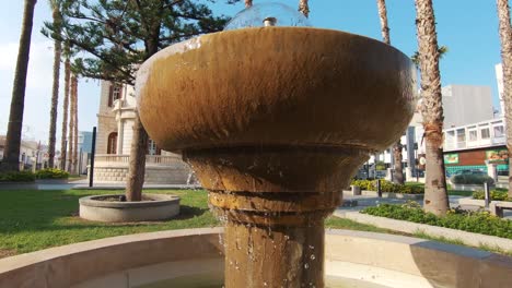 Garden-fountain-in-the-surrounding-area-of-Limassol-Municipal-Library-in-Cyprus---Wide-Crane-pan-shot