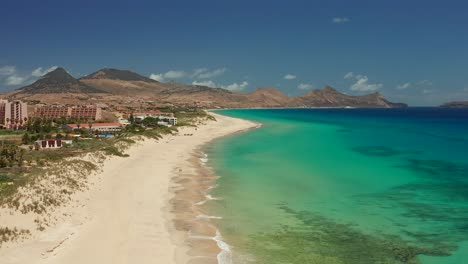 Aerial-shot-couple-walking-on-the-beach-Porto-Santo,-Madeira,-Portugal