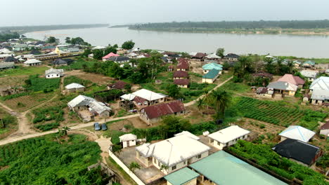 A-hawk-or-eagle-flies-through-the-aerial-view-of-the-Odi-Community-along-the-Nun-River