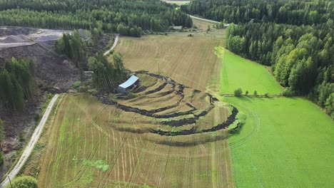 Large-landslide-near-NCC-operated-open-pit-construction-rock-quarry,-dirt-road-and-agricultural-field-and-barn-destroyed-due-to-shifting-soil