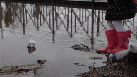 Little-Girl-Takes-The-Paper-Boat-Out-On-The-Water