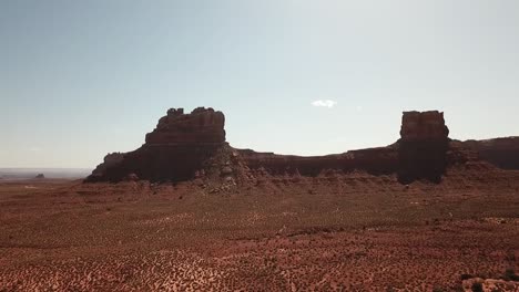 The-drone-is-flying-above-the-Valley-of-the-Gods,-toward-buttes-during-the-day-and-hot-weather