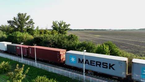 Aerial-view-offreight-train-with-shipping-containers-traveling-through-the-countryside