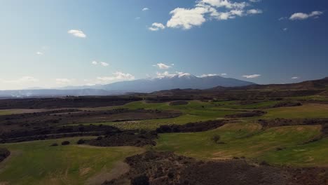 Drone-aerial-view-in-Spain-across-countryside-to-Moncayo-snow-mountain-landscape