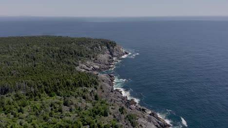 Drone-shot-flying-high-above-the-rocky-coastline-off-a-small-island-in-Maine