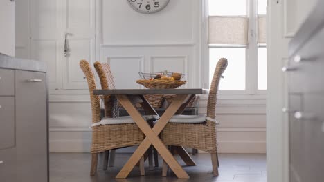 Slow-establishing-shot-of-a-wicker-table-and-chair-set-with-fresh-fruit-on-display