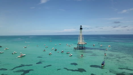 Drone-footage-of-boats-and-Alligator-Lighthouse-in-Atlantic-Ocean-off-coats-of-Islamorada,-Florida-Keys