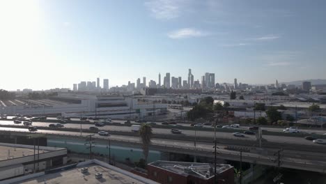 Aerial-flight-over-freeway-with-Los-Angeles-Skyline