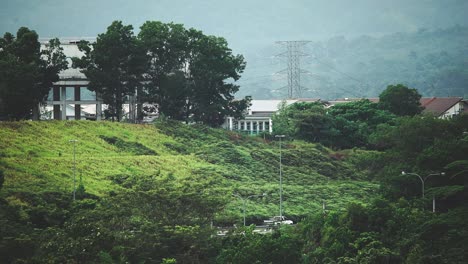 A-highway-near-residential-area_car-crossing_bird-flying_morning-routine_off-to-work_long-shot_50fps