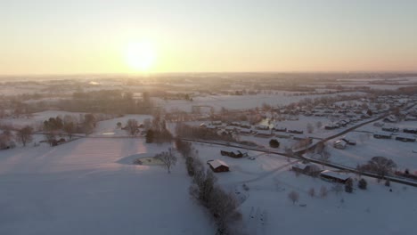 Dolly-Forward-Towards-the-Sunrise-over-a-Snow-Covered-Neighborhood-and-Countryside