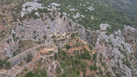 Aerial-dolly-in-with-cinematic-parallax-effect-over-St-John-Castle-high-above-the-Bay-of-Kotor-in-Montenegro