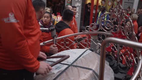 Close-view-of-a-man-playing-the-drum-percusion-making-loud-noise-in-chinese-new-year-celebration-in-china-town-london-england-2020