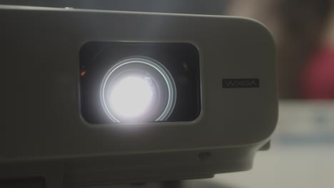 Pupil-at-school-watching-film-on-laser-beamer,close-up-shot-of-light