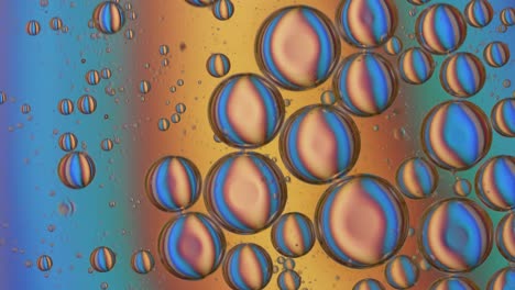 Close-up-shot-of-multicolored-oil-bubbles-rotating-in-liquid