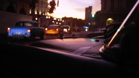 Dramatic-cinematic-sunset-clip-on-the-streets-of-Havana-as-the-sun-goes-down-and-rows-of-vintage-taxis-drive-past