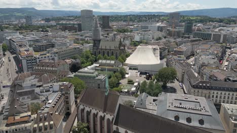 4K-Drone-Video-of-Trains-and-Skyline-of-Basel,-Switzerland-with-Historic-Buildings,-Gothic-Churches,-and-Modern-Opera-House