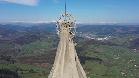 Aerial-drone-view-of-a-large-monument-statue-of-the-Virgin-of-Orduña-on-the-top-of-Mount-Txarlazo-in-the-Basque-Country