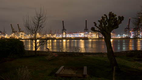 Hamburg-harbor,-container-terminal-at-night-colorful-illuminated,-time-lapse