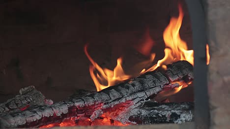 Firey-burning-wooden-logs-inside-rustic-pizza-oven