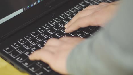 Typing-on-laptop-keyboard---closeup-shot