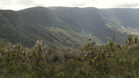 4k-Drone-shot-orbiting-people-on-a-trail-path-with-big-rocks-on-a-mountain-spine