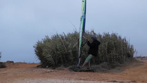 Slow-motion-of-Portuguese-windsurfer-trying-out-his-sail-on-a-skate-and-going-super-fast