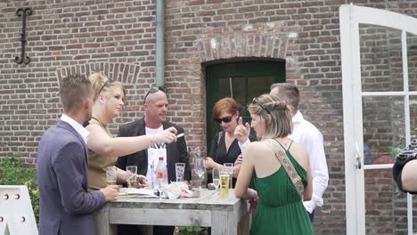 Happy-family-members-drinking-and-smoking-outside-the-wedding-party