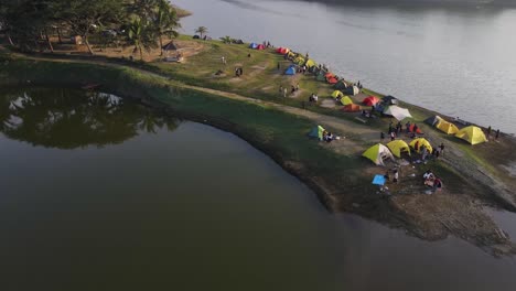 Aerial-view,-a-very-beautiful-campsite-on-the-edge-of-the-Sermo-reservoir,-Kulon-Progo,-Yogayakarta