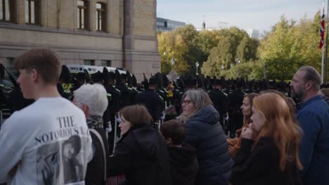 People-watching-Royal-Guard-parade-on-Karl-Johan-in-Oslo-in-front-of-the-Storting