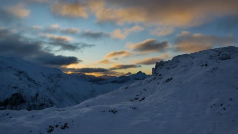 Scenic-sunset-behind-the-snowy-mountains-in-Fiordland,-Kepler-trek-in-New-Zealand