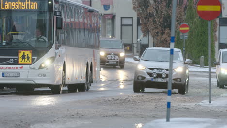 Vehicles-drive-through-the-slush-covered-streets-in-a-Swedish-town-during-the-covid-19-pandemic