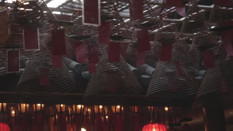 Interior-of-Buddhist-Temple,-Lights,-Smoke-and-Flags