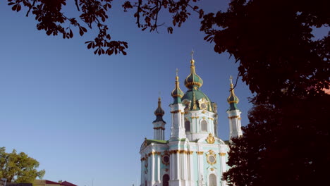 Wide-tilt-down-from-tree-to-the-exterior-of-St-Andrews-Church-Kiev-on-an-early-autumn-morning