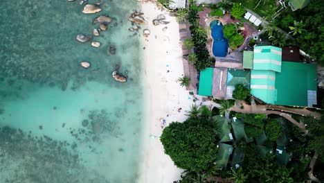 Aerial-top-down-overview-of-Coral-Beach-on-Koh-Samui,-featuring-clear-waters-and-a-scenic-tropical-coast