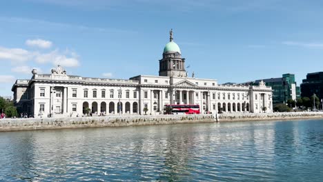 View-across-the-Liffey-River-onto-the-southern-facade-of-Custom-House-in-Dublin-City-on-a-sunny-day-with-blue-skies